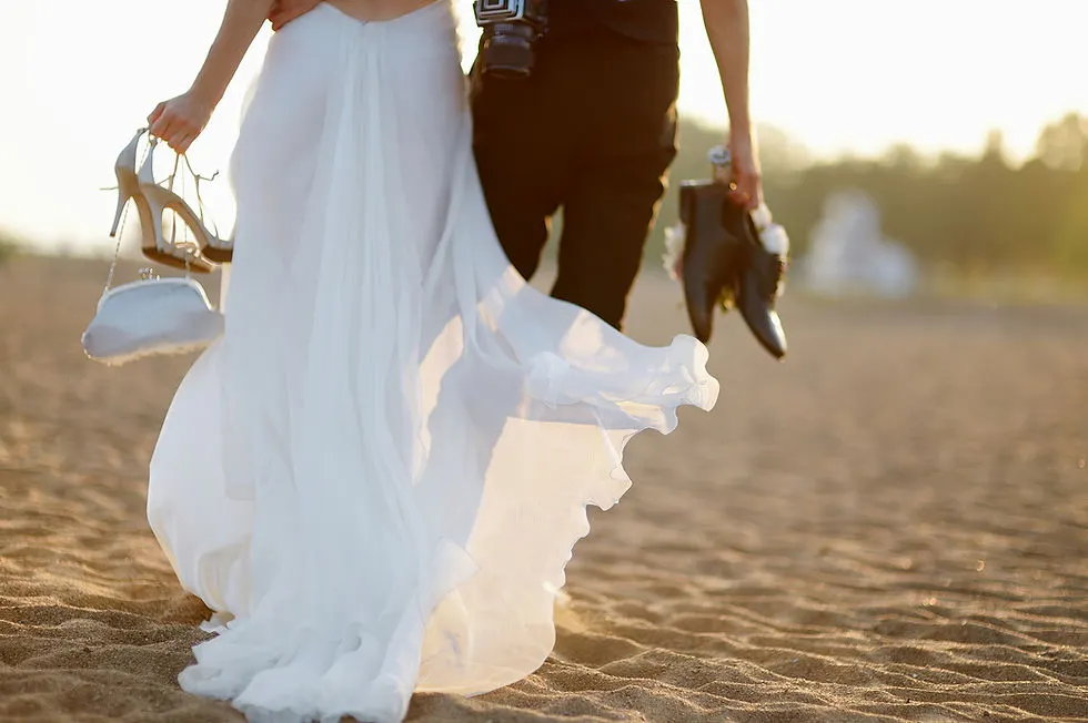 Bride and Groom Walking in Sand
