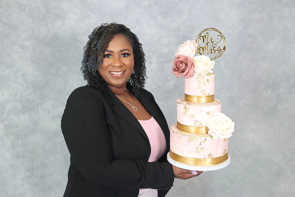 Holding Pink and Gold Wedding Cake