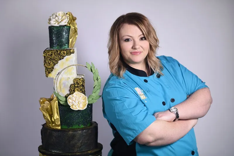 Owner Posing by Cake