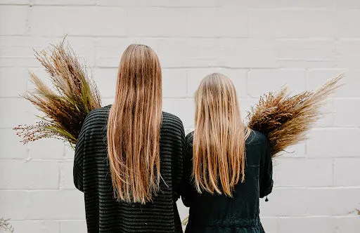 2 girls Holding Floral