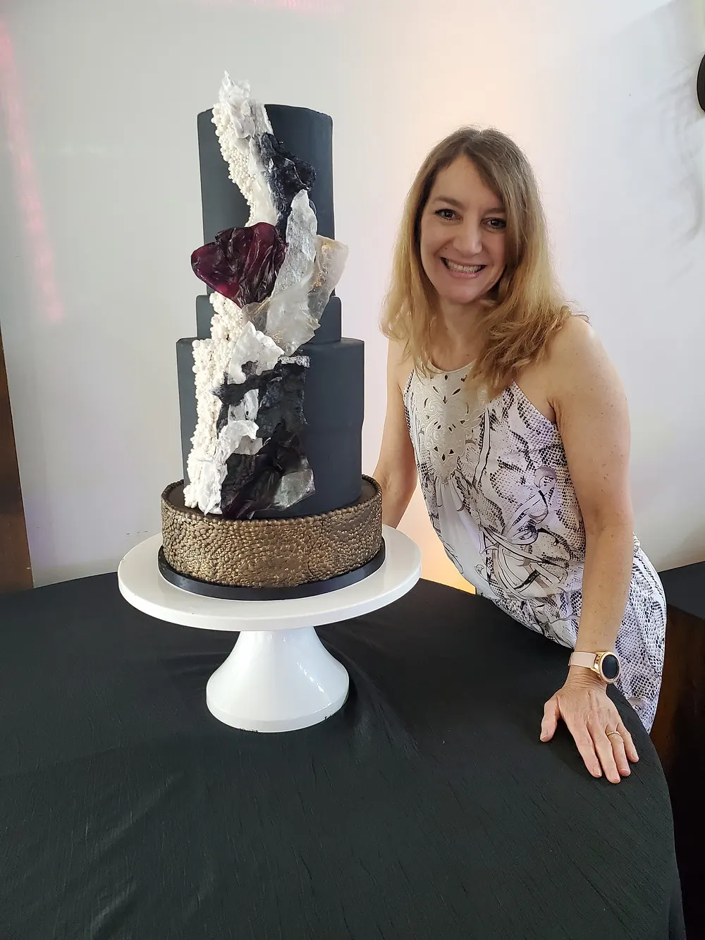 Posing with Tall Black Wedding Cake