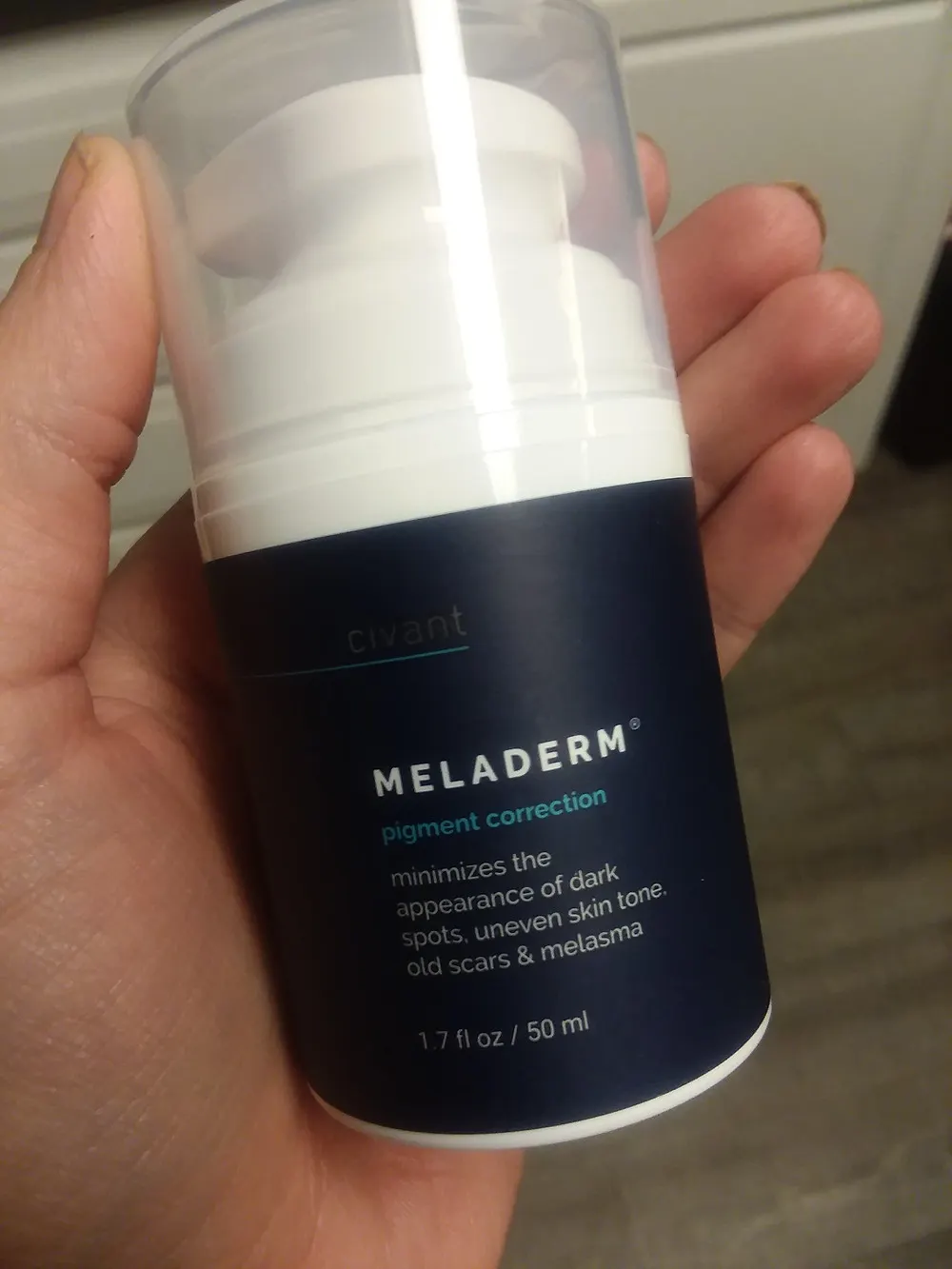 Holding Bottle of Meladerm